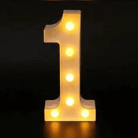 Mandotos luminous letter lights spelling out a word, illuminated in warm white, perfect for decorative home lighting.