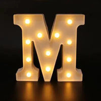 Mandotos luminous letter lights spelling out words, glowing soft white, decorative indoor lighting for home decor and ambiance.