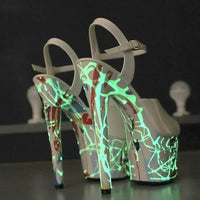 Elegant lustrous leather stilettos by MANDOTOS featuring sleek pointed toes and shiny finish on a neutral background.
