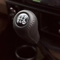 Luxury leather gear shift kit by MANDOTOS featuring a sleek, high-quality leather cover for car gear shifter.