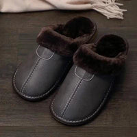 Men's luxury leather slippers by MANDOTOS featuring soft leather upper and comfortable slip-on design.