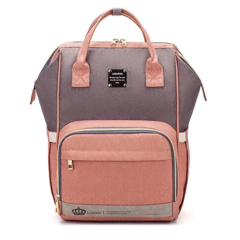 Mandotos Mummy Maternity Bag with multiple compartments, beige fabric, and sturdy handles for expecting mothers.