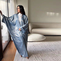 Mandotos Muslim robe abaya in black fabric with flowing design, traditional modest dress for women.