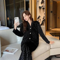 Gold velvet women's pajamas set by MANDOTOS, featuring a comfortable long-sleeve top and matching pants for cozy sleepwear.