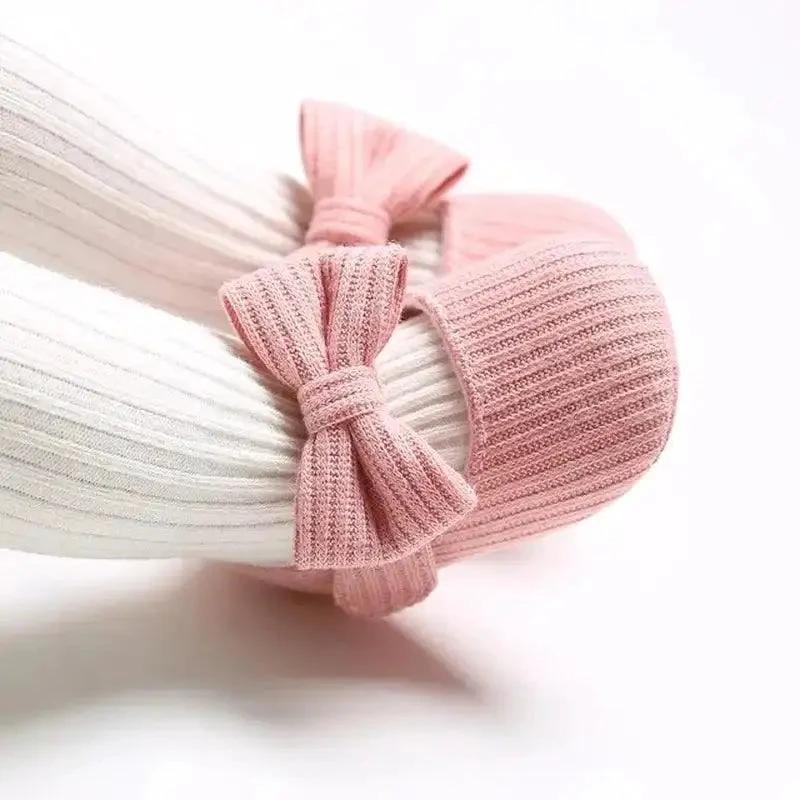 Soft newborn shoes by MANDOTOS, lightweight and plush for tiny feet, featuring a gentle design suitable for infants.