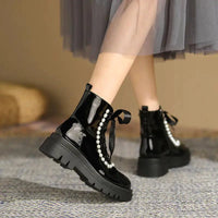 Mandotos patent leather ankle boots with sleek design and pointed toes, featuring a shiny finish and sturdy block heels.