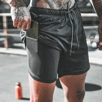 Mandotos pocket compression shorts showing a close-up of black athletic shorts with built-in pocket and elastic waistband for active wear.