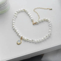 Mandotos round medal pearl necklace featuring irregular pearls, elegant jewelry piece with a classic design.