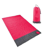 Mandotos sandproof portable beach mat spread out on sandy shore, lightweight and foldable for easy beach outings.