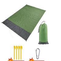 Mandotos sandproof portable beach mat spread on sandy shore, lightweight and foldable for easy beach outings.