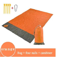 Mandotos sandproof portable beach mat spread out on sandy beach, lightweight and easy to carry for relaxing seaside outings.
