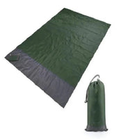 Mandotos sandproof portable beach mat spread out on sandy beach, lightweight and easy to carry for outdoor relaxation.