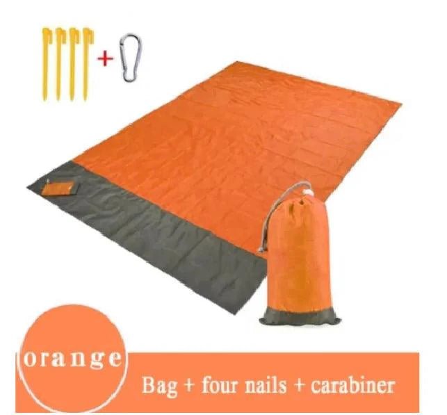 Mandotos sandproof portable beach mat spread on sandy shore, lightweight and durable for easy beach outings.