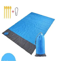 Mandotos sandproof portable beach mat spread out on sandy shore, lightweight and foldable for easy beach outings.