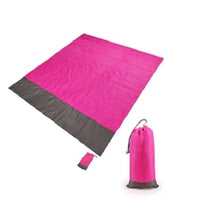 Mandotos sandproof portable beach mat spread on sandy shore, lightweight and foldable for convenient beach outings.