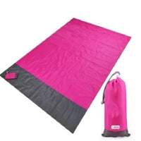 Mandotos sandproof portable beach mat spread out on sandy shore, lightweight and durable for outdoor beach outings.