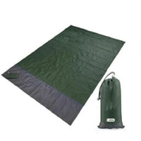 Mandotos sandproof portable beach mat spread out on sandy shore, lightweight and easy to carry for outdoor beach activities.