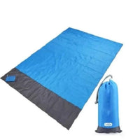 Mandotos sandproof portable beach mat spread out on sandy shore, lightweight and durable for outdoor beach outings.