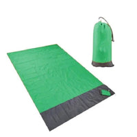 Mandotos sandproof portable beach mat laid out on sandy shore, lightweight and easy to carry for outdoor beach outings.