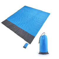 Mandotos sandproof portable beach mat spread on sandy shore, lightweight and easy to carry for outdoor beach relaxation.