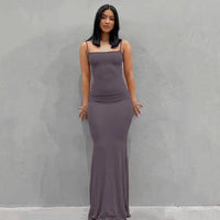 Mandotos sleek satin backless gown featuring a smooth, flowing fabric and elegant design for formal occasions.