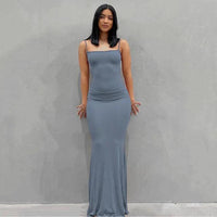 Mandotos sleek satin backless gown featuring a smooth, shiny fabric and elegant design perfect for formal occasions.