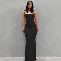Mandotos sleek satin backless gown featuring a smooth, shiny fabric and elegant design perfect for formal occasions.