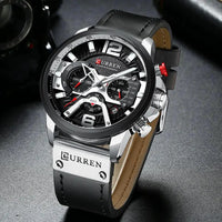 Mandotos Tactical Elegance leather watch with black dial, stainless steel case, and brown leather strap on a minimalist background.