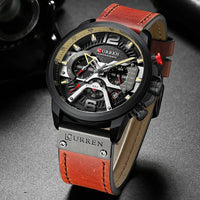 Mandotos Tactical Elegance leather watch with black dial, silver case, and brown leather strap displaying time and date.