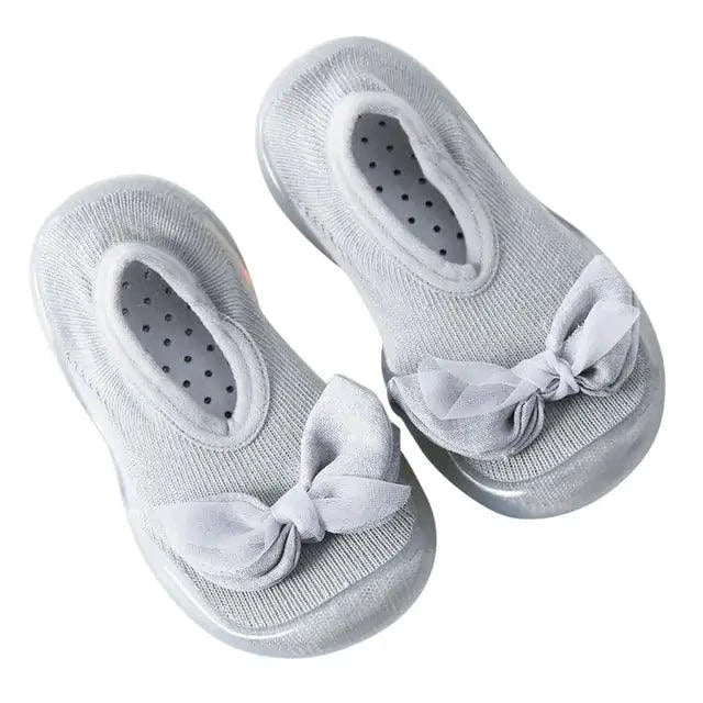 Pair of MANDOTOS toddler shoes featuring soft fabric and Velcro straps, designed for comfort and easy wear for young children.