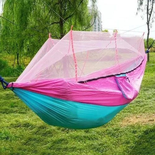 Mandotos Traveler's Mosquito-Free Hammock hanging outdoors with integrated mosquito net and comfortable fabric for outdoor relaxation.
