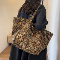 Urban Leopard Canvas Tote bag by MANDOTOS featuring leopard print fabric and sturdy handles for everyday use