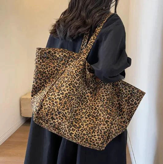 Urban Leopard Canvas Tote bag by MANDOTOS featuring leopard print fabric and sturdy handles for everyday use