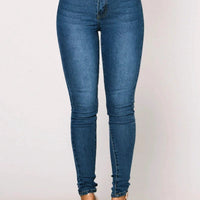 Mandotos women’s high waist stretch denim skinny jeans with full length, solid color, and hip lift design on a model.
