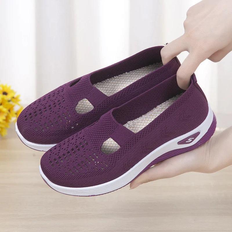 Women's airy mesh sneakers by MANDOTOS with breathable design, white and gray color, and comfortable athletic fit.